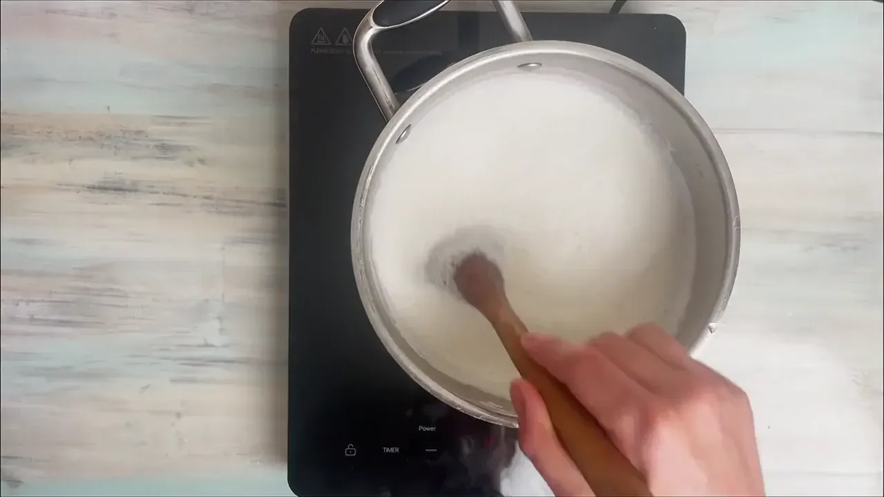 Remove the saucepan from the heat, pour in the strained lemon juice, and gently stir once to distribute. Cover with a lid and leave undisturbed for 20 minutes to curdle.