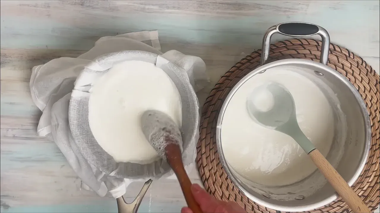 Line a fine-mesh sieve with a double layer of clean cheesecloth or a nut-milk bag and place it over a large bowl. Gently ladle the warm curdled milk into the lined sieve.