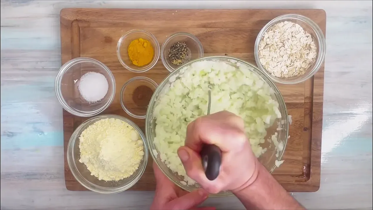 Transfer the cauliflower to a large mixing bowl and mash with a potato masher, leaving small tender chunks for texture.