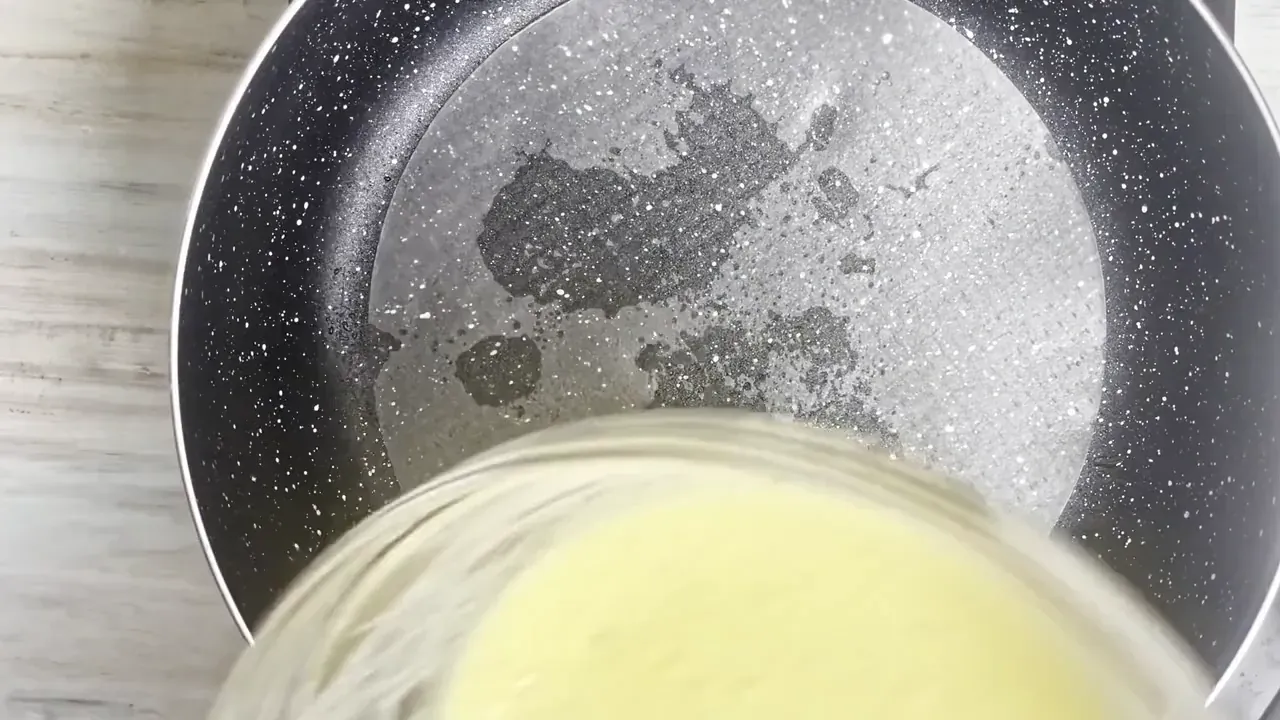 Brush a cold non-stick skillet with olive oil. Lay one dry rice paper sheet flat on the pan, then pour half of the batter over the sheet while still off the heat.