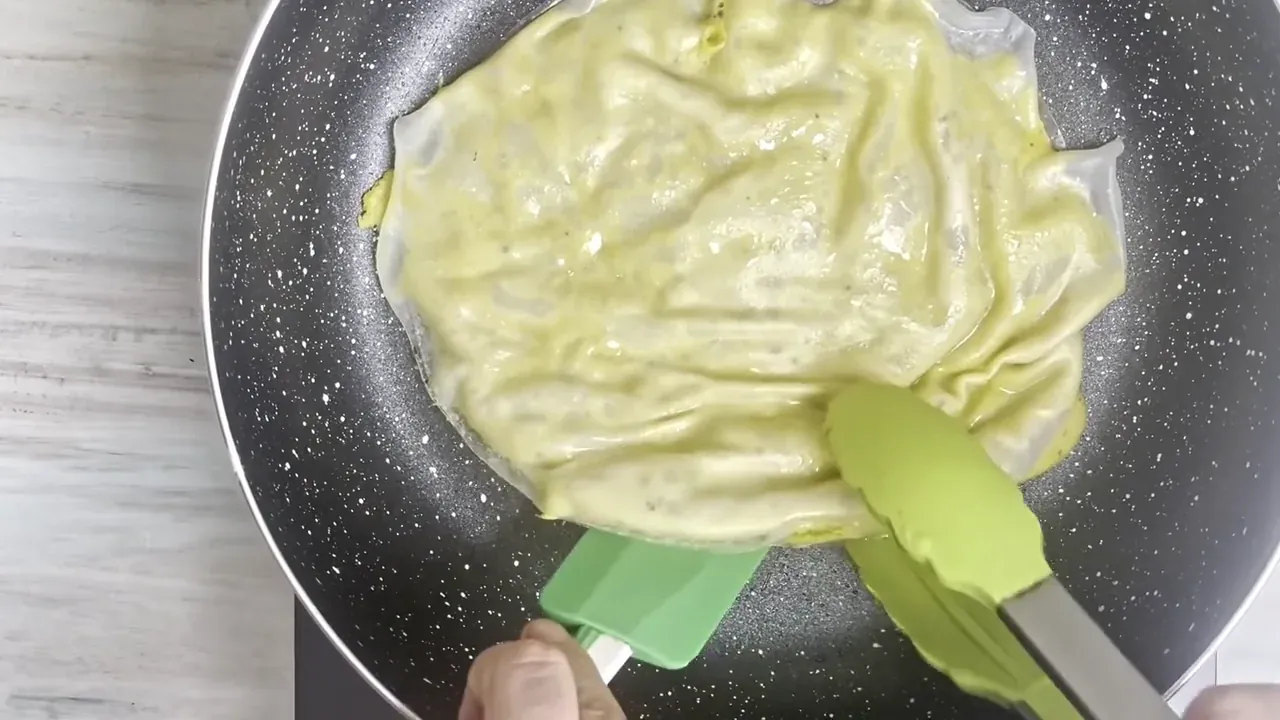 Cook over gentle heat for 4 to 5 minutes until the bottom rice paper is crisp and golden, then flip and cook the other side for another 3 to 4 minutes.