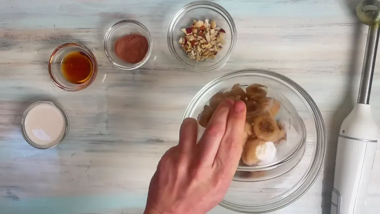 Place the frozen banana coins into a high-speed blender or food processor bowl.