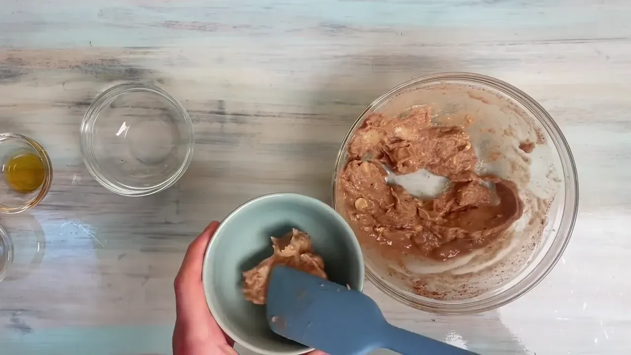Once the mixture turns completely smooth, glossy, and aerated into thick chocolate soft-serve, spoon it straight into chilled dessert bowls.