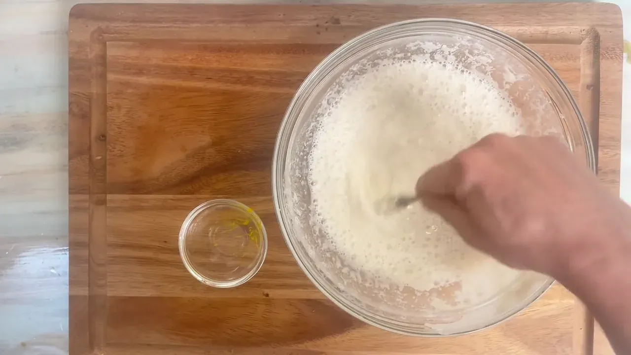 I whisk the flour, cold sparkling water, and turmeric into a smooth, light batter.