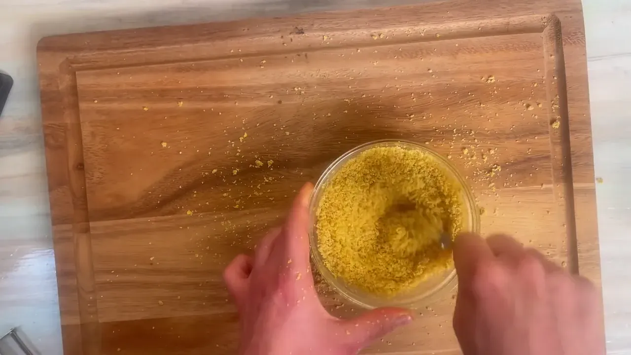Pulse in short 1-second bursts until the liquid incorporates and the mixture resembles fine, slightly damp, golden cheese crumbs.
