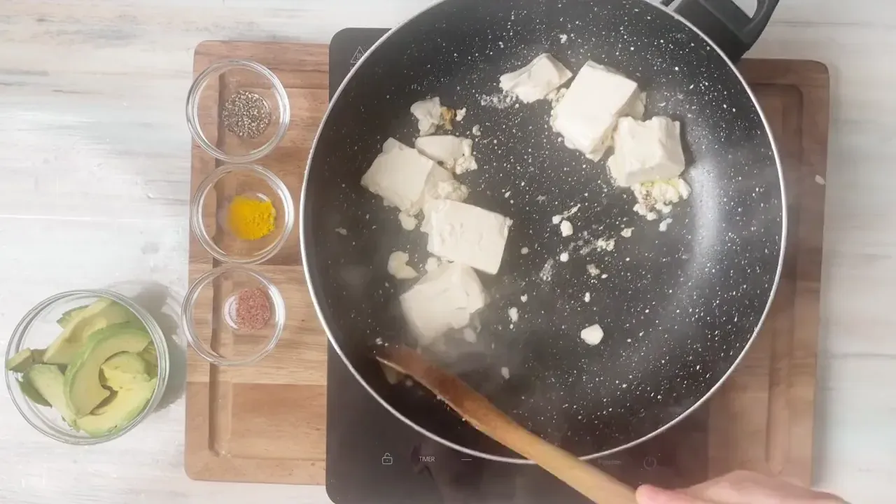 In a hot, dry non-stick skillet, drop the silken tofu in large chunks. Let the bottom sear for 1 to 2 minutes before touching it.