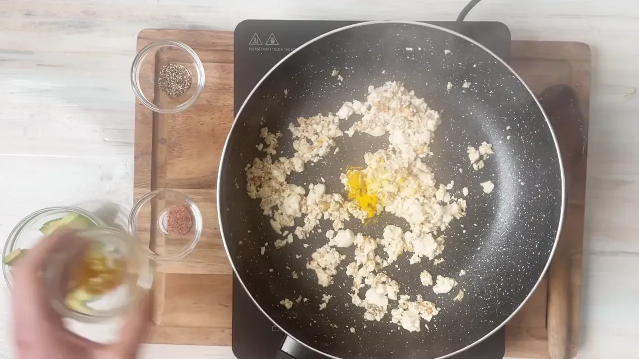 Stir in the turmeric, black pepper, nutritional yeast, and kala namak. Sauté for 1 minute so the spices bloom in the heat.