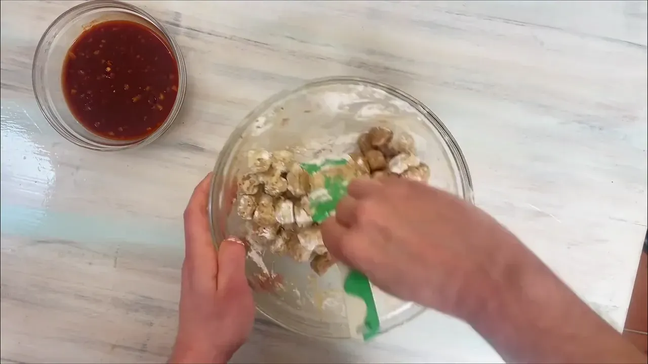 In a separate bowl, toss the squeezed soy with garlic powder, black pepper, cumin, nutmeg, lemon juice, 20 g maple syrup, and 30 g soy sauce. Dust with the 4 tablespoons of cornstarch and toss until each chunk has a matte, dry coating.