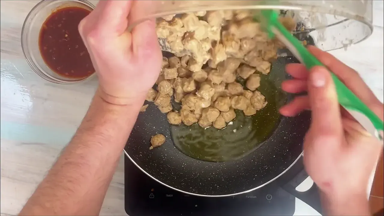Heat half of the olive oil in a wide pan over medium-high heat. Sear the coated soy chunks in batches until golden and crisp around the edges, then remove to a plate.