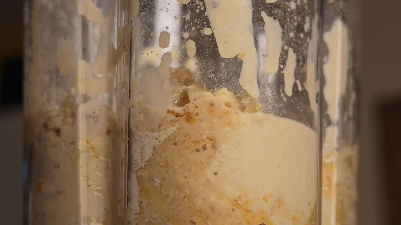 Smooth pale chickpea and tofu paste inside a blender jar