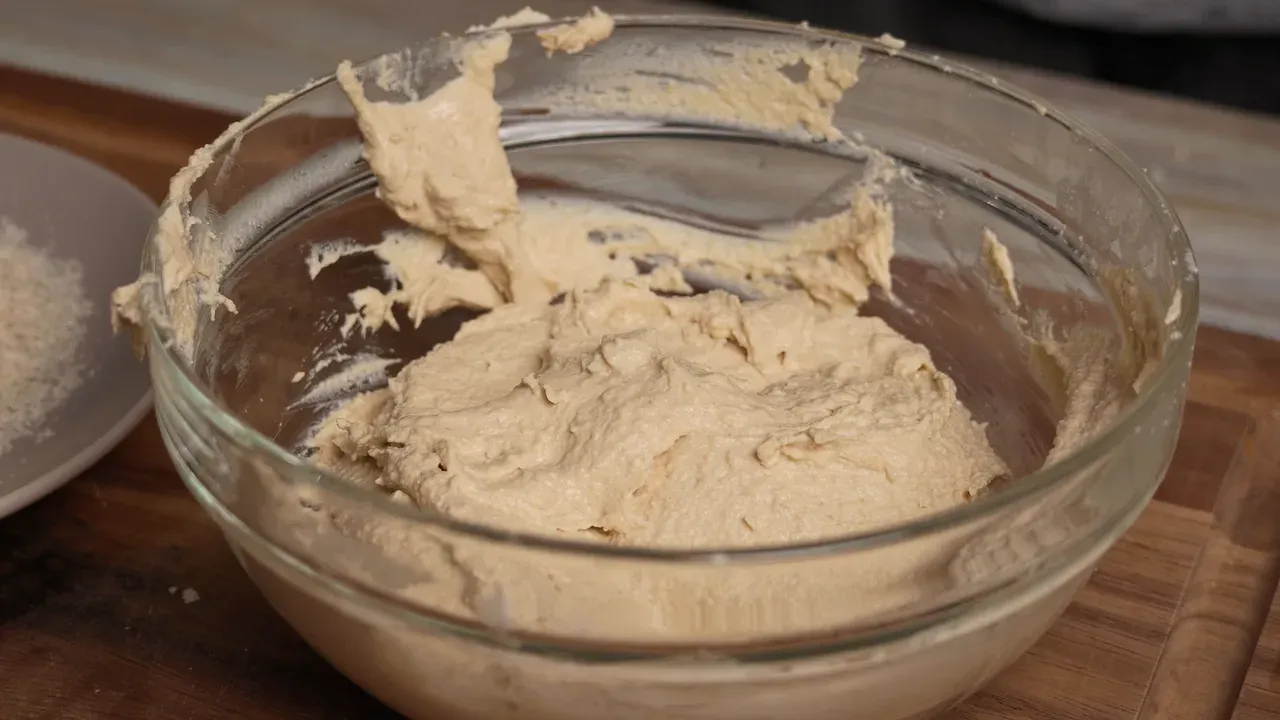 Soft, thick tofu and chickpea dough in a glass bowl