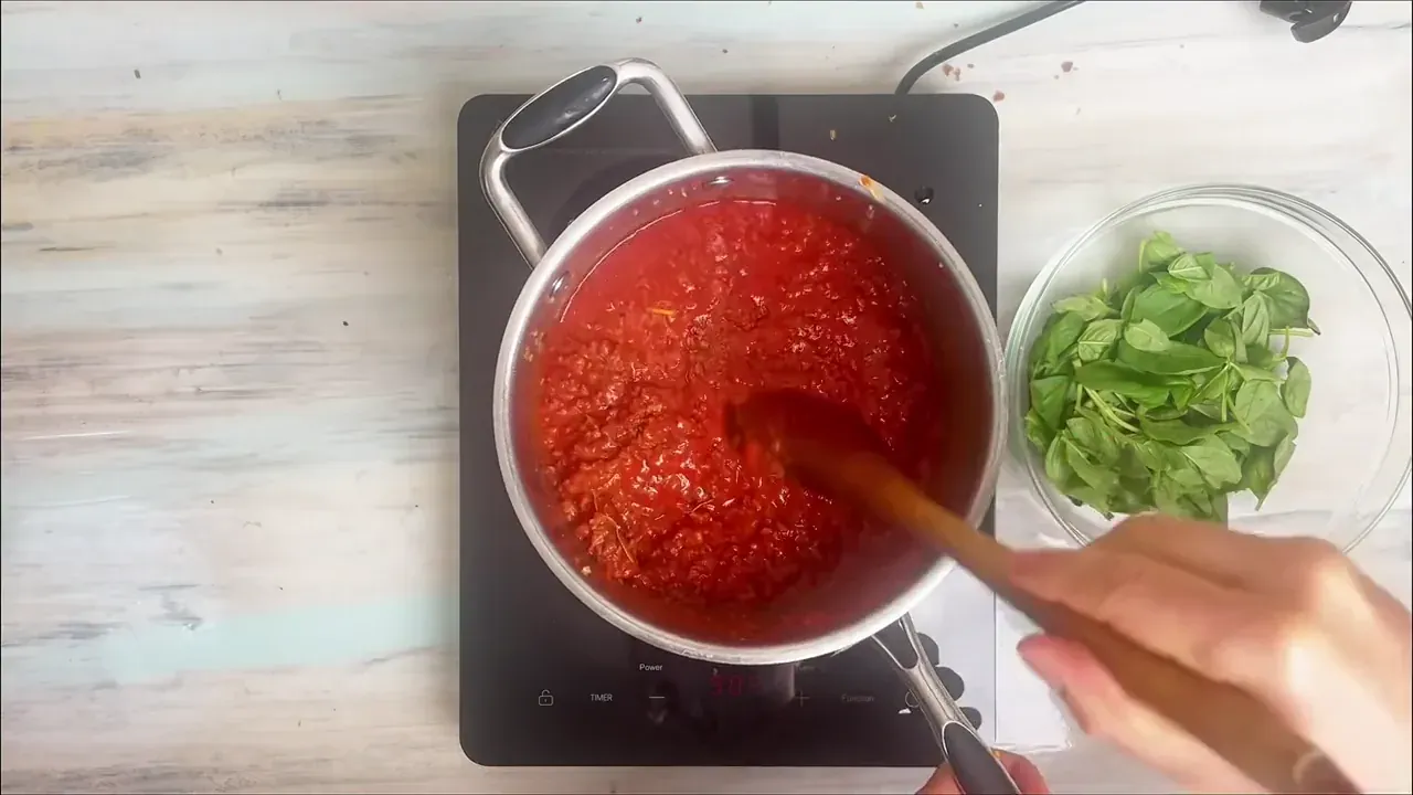 Drop in the 2 bay leaves, salt, and freshly ground black pepper. Stir thoroughly and bring the ragù to a gentle simmer.