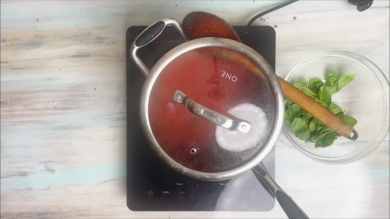 Cover the pot partially with a lid and reduce the heat to low. Let the sauce simmer gently for 35 to 40 minutes, stirring occasionally, until deeply thickened and glossy.