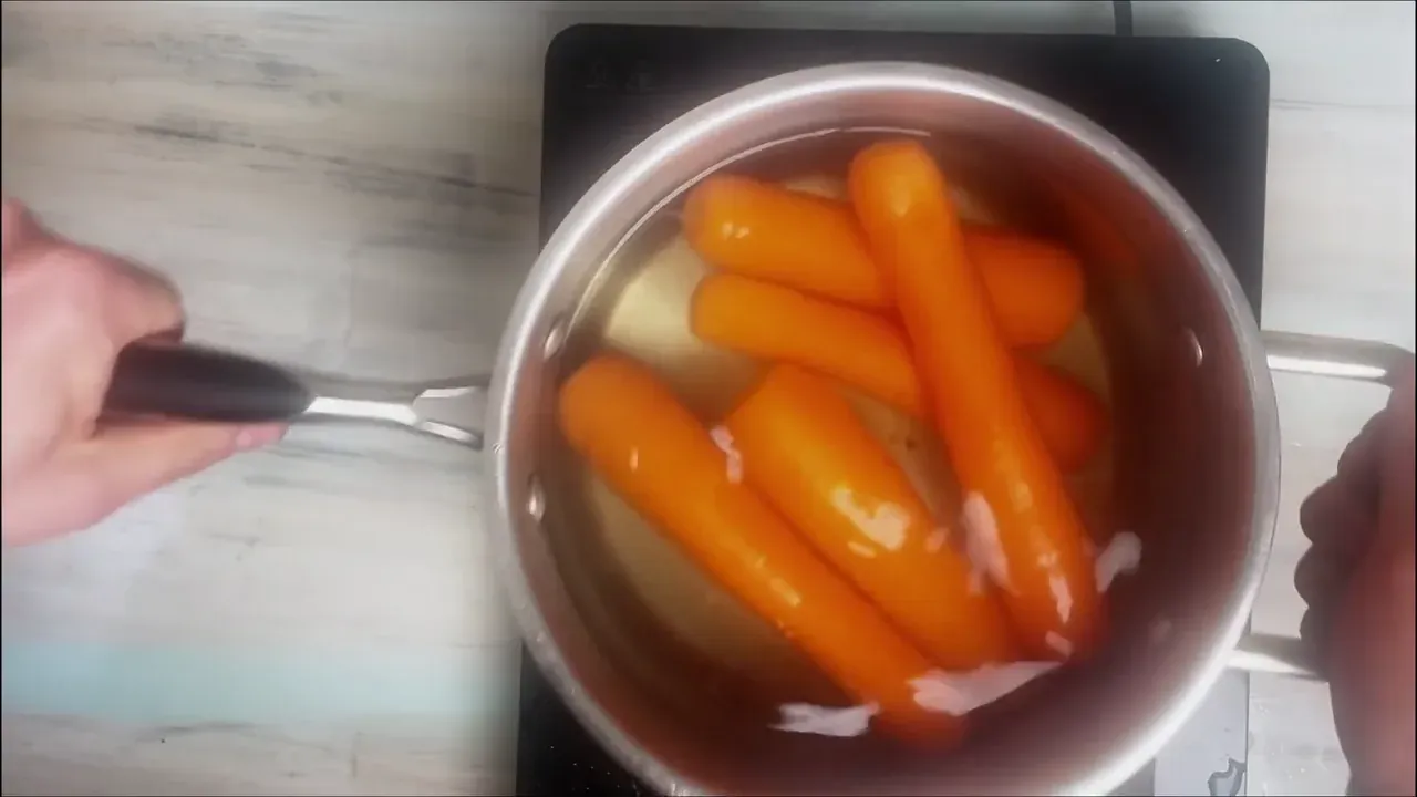 Bring a saucepan of water to a rolling boil. Add the whole carrots, reduce heat to medium, and simmer for 15 to 20 minutes until tender-crisp.