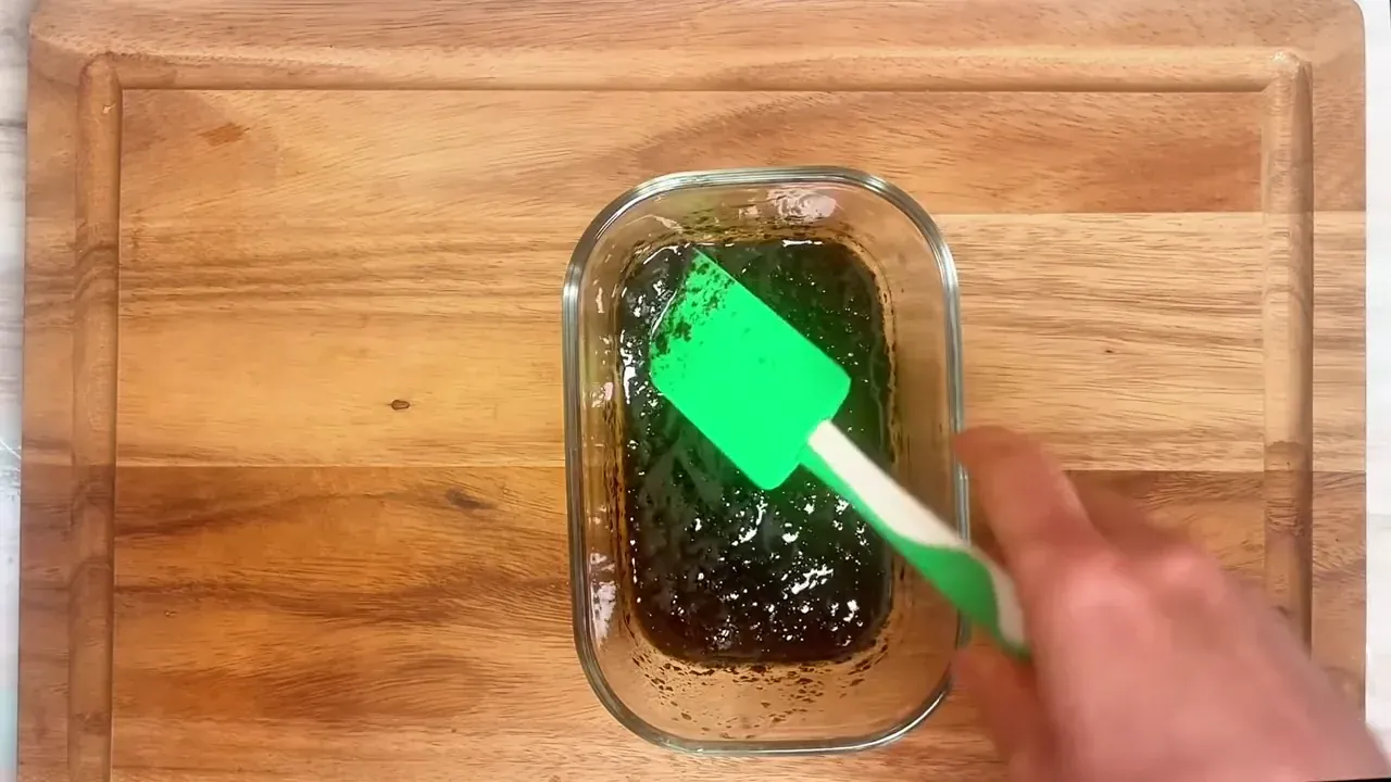 While the carrots cook, prepare the marinade in an airtight glass container by whisking together sesame oil, soy sauce, agave syrup, crumbled nori flakes, and liquid smoke until emulsified.