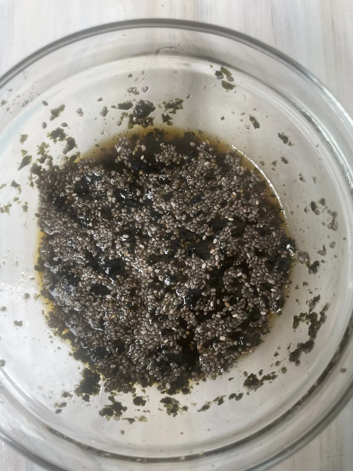 Shining black chia seed vegan caviar pearls in a clear glass bowl