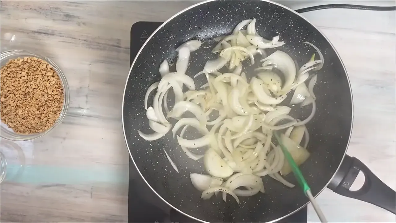 Heat the olive oil in a wide skillet over medium-low heat. Add the diced onion with a pinch of salt and cook slowly for 8 to 10 minutes until soft, translucent, and sweet.
