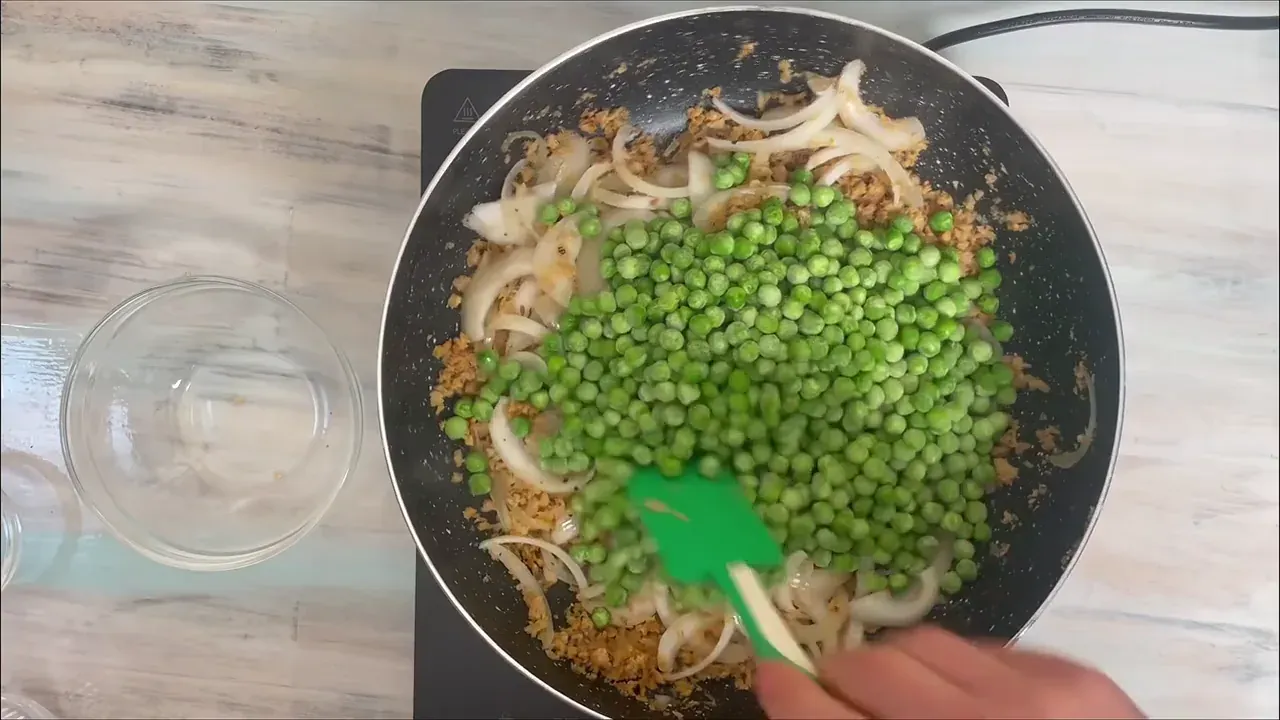 Stir in the green peas, remaining salt, and freshly ground black pepper.