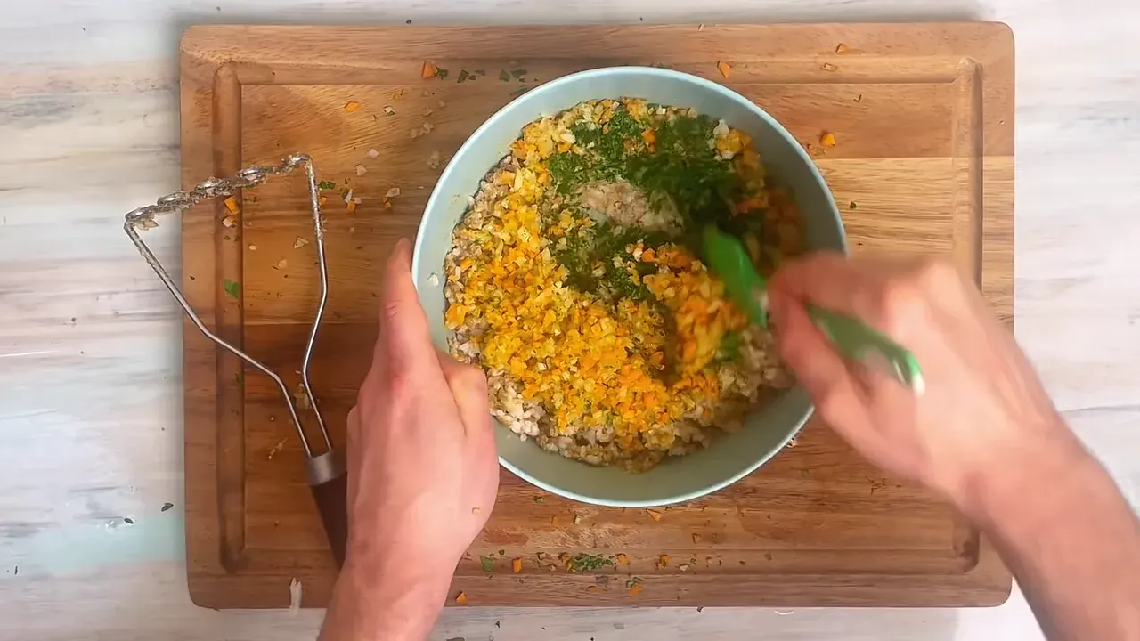 Add the minced vegetables and pour the seasoned miso-soy liquid over the mashed rice and lentil mixture. Mix well with a spoon until thoroughly combined.