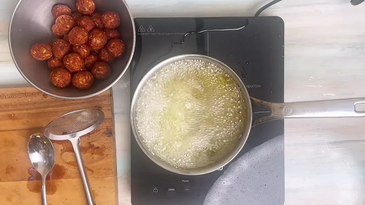 Fry the veggie balls in batches of 6 to 8 for 3 to 4 minutes, turning gently with a slotted spoon, until deeply golden brown and crispy all over.