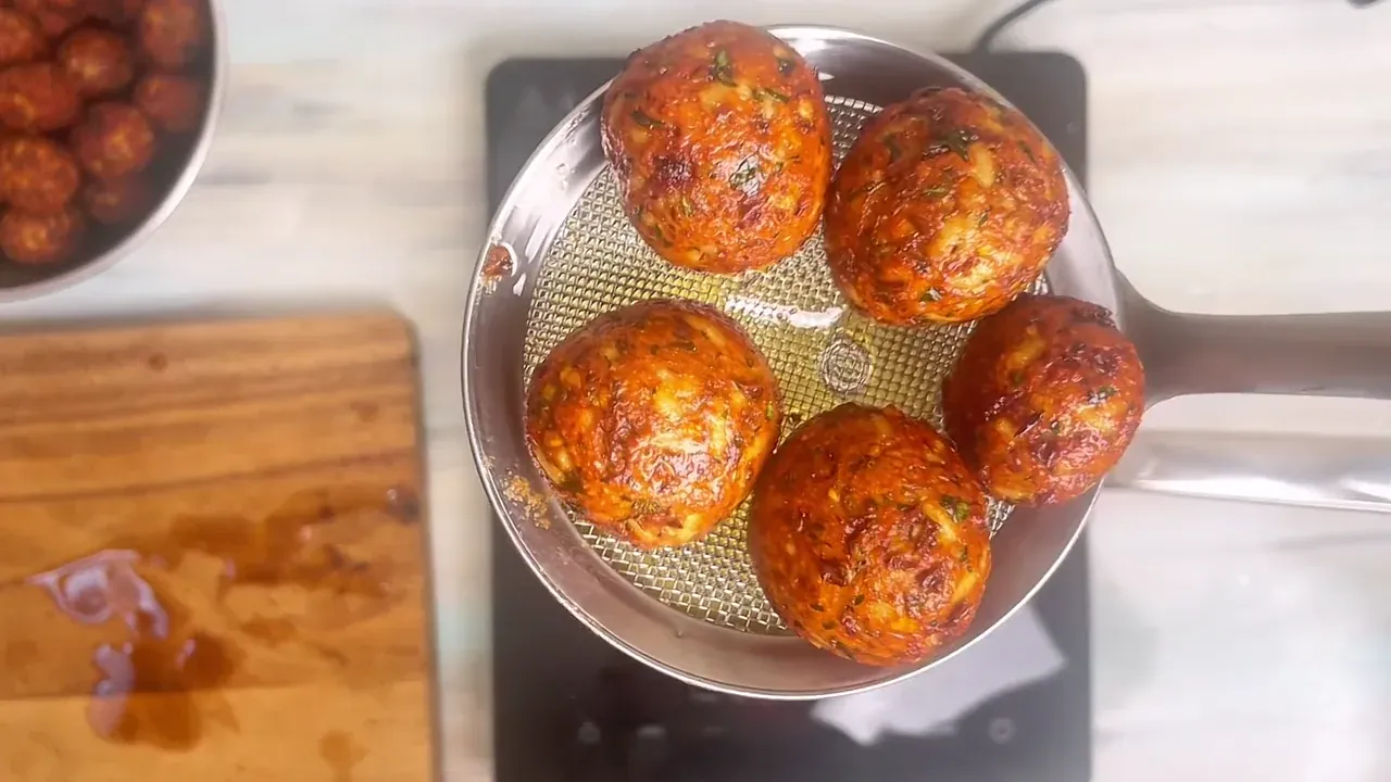 Lift the balls from the oil using a slotted spider, drain on paper towels, and serve warm with dipping sauces or tossed in warm tomato sauce.