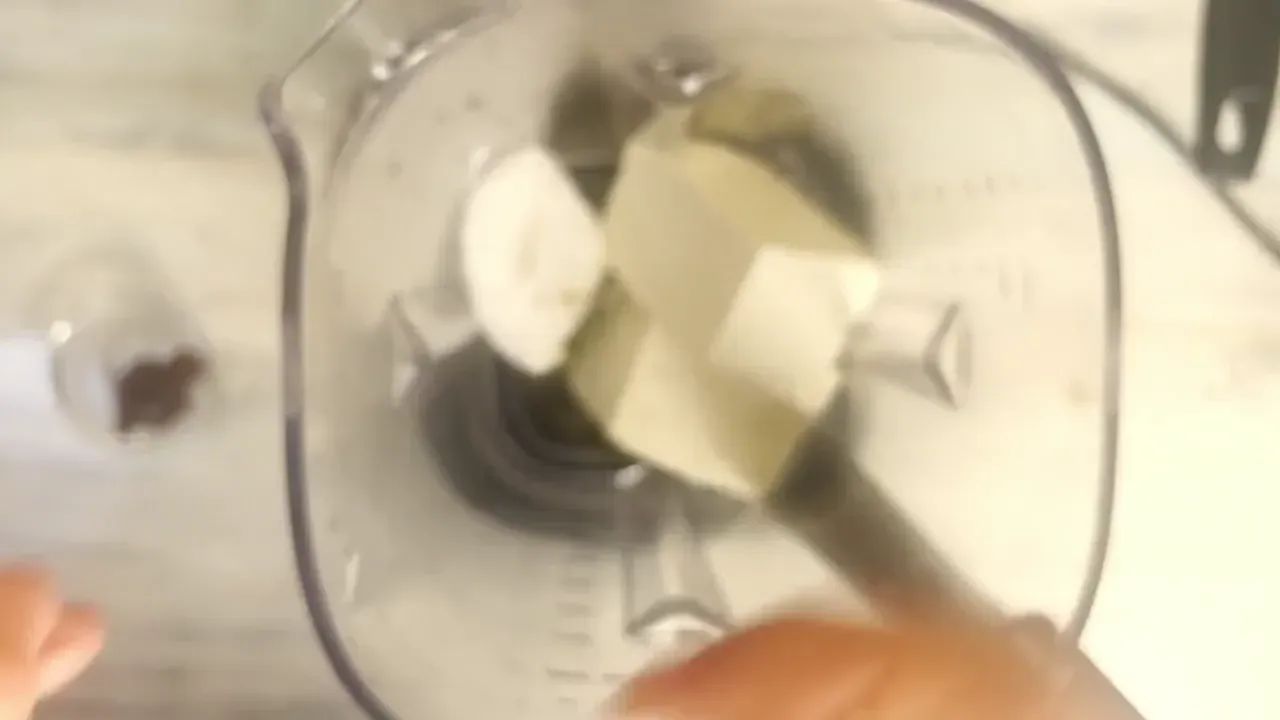 Into the blender, add the ingredients in this exact order: first a drizzle of olive oil (1 tbsp) on the bottom, then the drained firm tofu, crumbled vegan feta, barley miso, and salt and pepper.