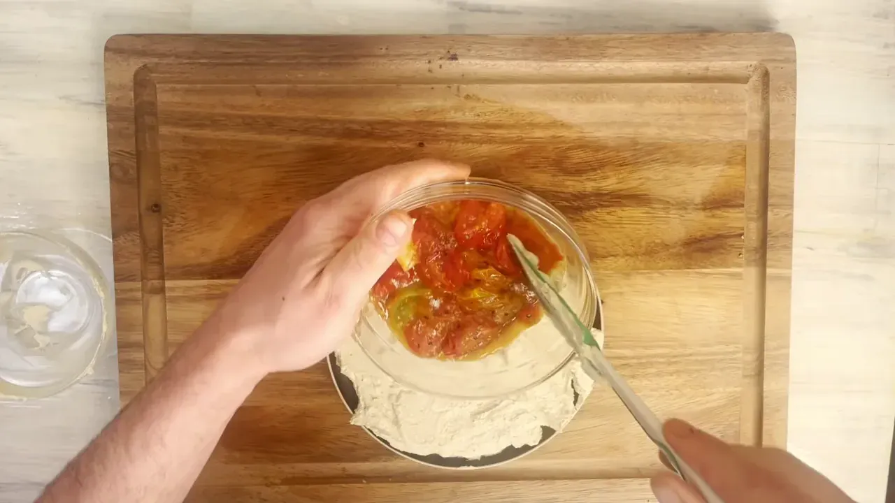 Spoon the warm tomato confit and all its warm pan juices directly over the cool whipped cream. Finish with fresh basil leaves, cracked black pepper, and a thin thread of extra virgin olive oil. Serve immediately with warm crusty bread.